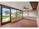 Screened-in porch with painted floor, and fan providing an ideal space for relaxation and enjoying the surroundings at 7630 Landmark Dr, Spring Hill, FL 34606