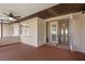 Inviting screened porch featuring textured walls, tiled flooring, ceiling fan, and doorway to the interior at 7630 Landmark Dr, Spring Hill, FL 34606