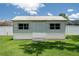 A small storage shed sits in the sunny backyard next to a white vinyl fence at 7630 Landmark Dr, Spring Hill, FL 34606
