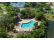Aerial view shows a community pool and multiple shaded cabanas for community residents at 7682 St Andrews Blvd, Weeki Wachee, FL 34613