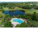 An aerial view shows a shared community pool and neighboring golf course at 7682 St Andrews Blvd, Weeki Wachee, FL 34613