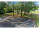 Community basketball court surrounded by mature trees and green space with a picnic table for relaxing at 7682 St Andrews Blvd, Weeki Wachee, FL 34613