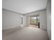 Bedroom with carpeted floors and sliding glass doors that lead to a lanai at 7682 St Andrews Blvd, Weeki Wachee, FL 34613