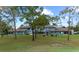 Two-story exterior with ample greenspace and lush trees, ideal for outdoor activities at 7682 St Andrews Blvd, Weeki Wachee, FL 34613