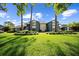 Well-maintained two-story condo building with green lawn and manicured landscaping at 7682 St Andrews Blvd, Weeki Wachee, FL 34613