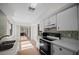 Eat-in kitchen with tile floors, appliances and sliding door access to lanai at 7682 St Andrews Blvd, Weeki Wachee, FL 34613