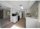Kitchen with tiled backsplash, white cabinets and black appliances at 7682 St Andrews Blvd, Weeki Wachee, FL 34613