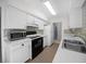 Bright kitchen featuring white cabinets, black appliances, and tiled backsplash at 7682 St Andrews Blvd, Weeki Wachee, FL 34613