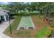 Enjoy the shuffleboard courts near the lake, with seating areas and well-maintained landscaping at 7682 St Andrews Blvd, Weeki Wachee, FL 34613