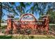 Entrance sign to Millpond Estates, featuring manicured landscaping and a welcoming design at 7807 Hardwick Dr # 123, New Port Richey, FL 34653