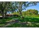Spacious community dog park surrounded by mature trees, providing a safe and enjoyable space for pets to play and socialize at 7807 Hardwick Dr # 123, New Port Richey, FL 34653