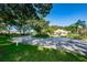 Circular driveway leading to the Millpond Estates clubhouse, surrounded by mature trees and landscaping at 7807 Hardwick Dr # 123, New Port Richey, FL 34653