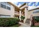 Inviting condo exterior featuring manicured landscaping and a well-maintained facade with stairs at 7807 Hardwick Dr # 123, New Port Richey, FL 34653