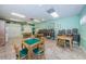 Well-lit game room with tables, chairs, and games storage, perfect for community entertainment and leisure at 7807 Hardwick Dr # 123, New Port Richey, FL 34653