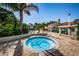 Inviting hot tub area with lush landscaping and nearby pool access, perfect for relaxation and enjoying the beautiful surroundings at 7807 Hardwick Dr # 123, New Port Richey, FL 34653