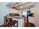 Charming kitchen features granite countertops, wood floors, breakfast bar, and flows into a sunlit dining area at 7807 Hardwick Dr # 123, New Port Richey, FL 34653