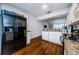 Well-lit kitchen featuring white cabinets, granite countertops, and black appliances at 7807 Hardwick Dr # 123, New Port Richey, FL 34653