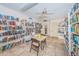 Bright library with extensive bookshelves, table, and chairs, creating an inviting reading space at 7807 Hardwick Dr # 123, New Port Richey, FL 34653