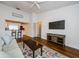 Spacious living room featuring hardwood floors, a flat screen television, and view into kitchen at 7807 Hardwick Dr # 123, New Port Richey, FL 34653
