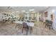 Open meeting room with lots of tables and chairs, light tile flooring and plenty of open space at 7807 Hardwick Dr # 123, New Port Richey, FL 34653