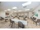 Well-lit meeting room with tables and chairs, perfect for community events in the Millpond Estates clubhouse at 7807 Hardwick Dr # 123, New Port Richey, FL 34653