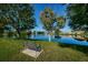 Scenic pond view with fountain, bench, and lush green surroundings, creating a tranquil and picturesque atmosphere at 7807 Hardwick Dr # 123, New Port Richey, FL 34653