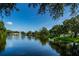 Picturesque view of a pond with a fountain, bordered by well-maintained lawns and mature trees for scenic beauty at 7807 Hardwick Dr # 123, New Port Richey, FL 34653