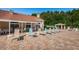 Relaxing pool deck with comfortable lounge chairs and tables, ideal for soaking up the sun and enjoying the outdoors at 7807 Hardwick Dr # 123, New Port Richey, FL 34653