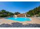 Bright and spacious community pool with brick trim and inviting lounge chairs, perfect for relaxation and socializing at 7807 Hardwick Dr # 123, New Port Richey, FL 34653