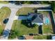 Overhead view shows the home with a solar panel roof, backyard pool, and fenced yard at 8388 Maltby Rd, Spring Hill, FL 34606