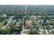 This aerial view highlights the property's location within a lush, green neighborhood with mature trees at 8388 Maltby Rd, Spring Hill, FL 34606