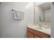 Powder room with a single sink vanity, a white countertop, and a mirror at 8388 Maltby Rd, Spring Hill, FL 34606