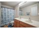 Bathroom features a double sink vanity and a shower with an anchor-themed curtain at 8388 Maltby Rd, Spring Hill, FL 34606