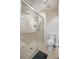 Modern bathroom features a glass shower, a built-in seat, and a toilet at 8388 Maltby Rd, Spring Hill, FL 34606