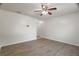 Bedroom features modern flooring, ceiling fan, and open closet at 8388 Maltby Rd, Spring Hill, FL 34606