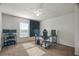 Bedroom has a desk, chair, ceiling fan, carpet, and a window for natural light at 8388 Maltby Rd, Spring Hill, FL 34606