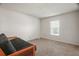 Carpeted bedroom with a futon, a window, and white walls at 8388 Maltby Rd, Spring Hill, FL 34606