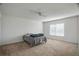 Carpeted bedroom featuring bed, window, and ceiling fan at 8388 Maltby Rd, Spring Hill, FL 34606