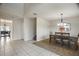 Formal dining room showcasing modern light fixtures, decorative mirror, and wood flooring at 8388 Maltby Rd, Spring Hill, FL 34606