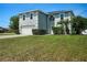 Charming two-story home featuring a well-manicured lawn and attached two-car garage at 8388 Maltby Rd, Spring Hill, FL 34606