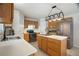 Well-lit kitchen with stainless steel appliances, ample counter space, and wood cabinets at 8388 Maltby Rd, Spring Hill, FL 34606