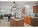 Open concept kitchen with island sink and stainless steel dishwasher overlooking the Gathering room at 8388 Maltby Rd, Spring Hill, FL 34606