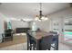 Gathering room with wood flooring, pool views through sliding glass doors, and ceiling fan at 8388 Maltby Rd, Spring Hill, FL 34606