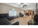 Bright living room open to kitchen featuring hardwood floors, lots of light, and neutral paint colors at 8388 Maltby Rd, Spring Hill, FL 34606