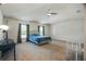 Spacious main bedroom features a ceiling fan, plush carpet, and natural light from the windows at 8388 Maltby Rd, Spring Hill, FL 34606