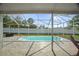 Private backyard pool area is enclosed by a screen and surrounded by a patio at 8388 Maltby Rd, Spring Hill, FL 34606