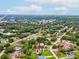 Expansive aerial view of a home with a pool nestled in a lush, green neighborhood with mature trees at 8393 Delaware Dr, Weeki Wachee, FL 34607