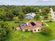 An aerial view of the home with screened pool, and large, grassy yard at 8393 Delaware Dr, Weeki Wachee, FL 34607
