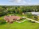 An aerial view of the house showcasing the beautiful landscaping and long driveway at 8393 Delaware Dr, Weeki Wachee, FL 34607