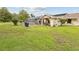 Lush backyard features green grass, mature trees, and a screened in pool area at 8393 Delaware Dr, Weeki Wachee, FL 34607